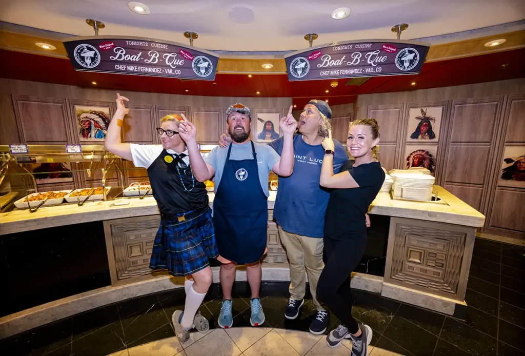 A group of people standing in front of buffet.