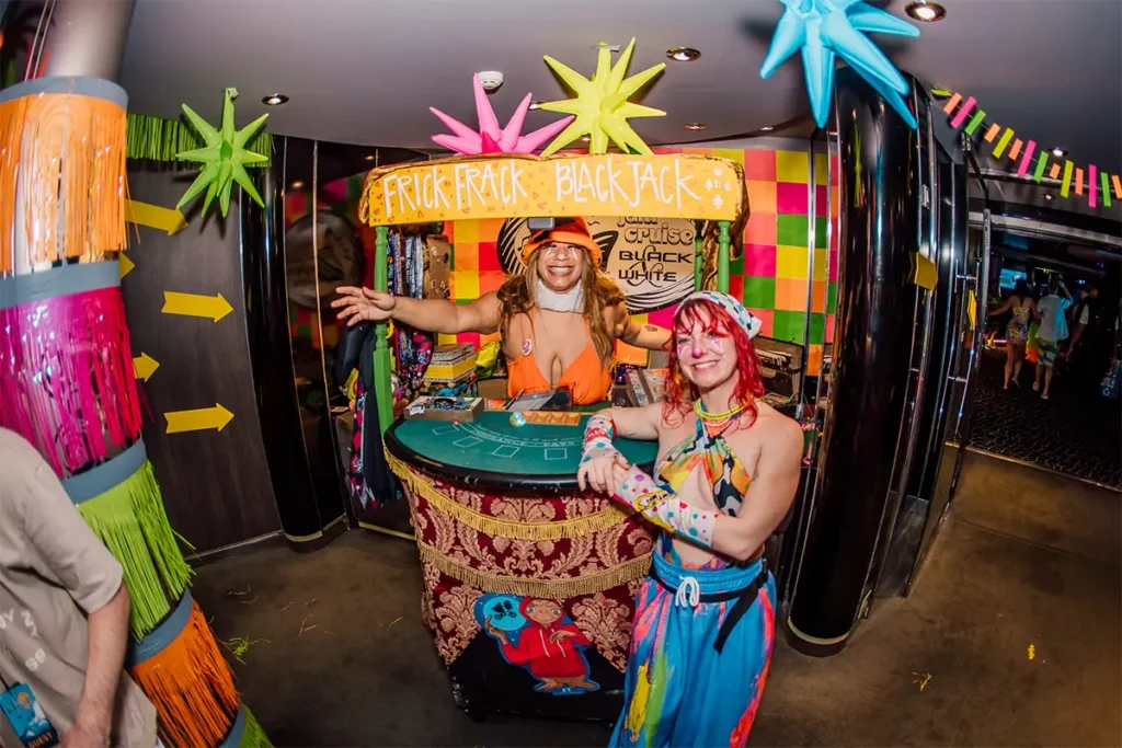 Two people standing in front of a portable blackjack table.