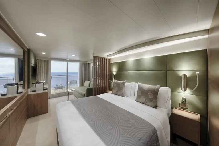 The main bedroom area of a Yacht Club cabin with an ocean view balcony.