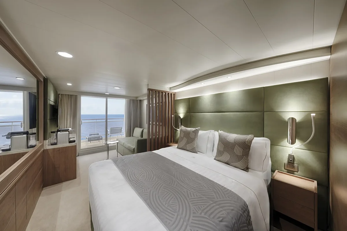 The main bedroom area of a Yacht Club cabin with an ocean view balcony.