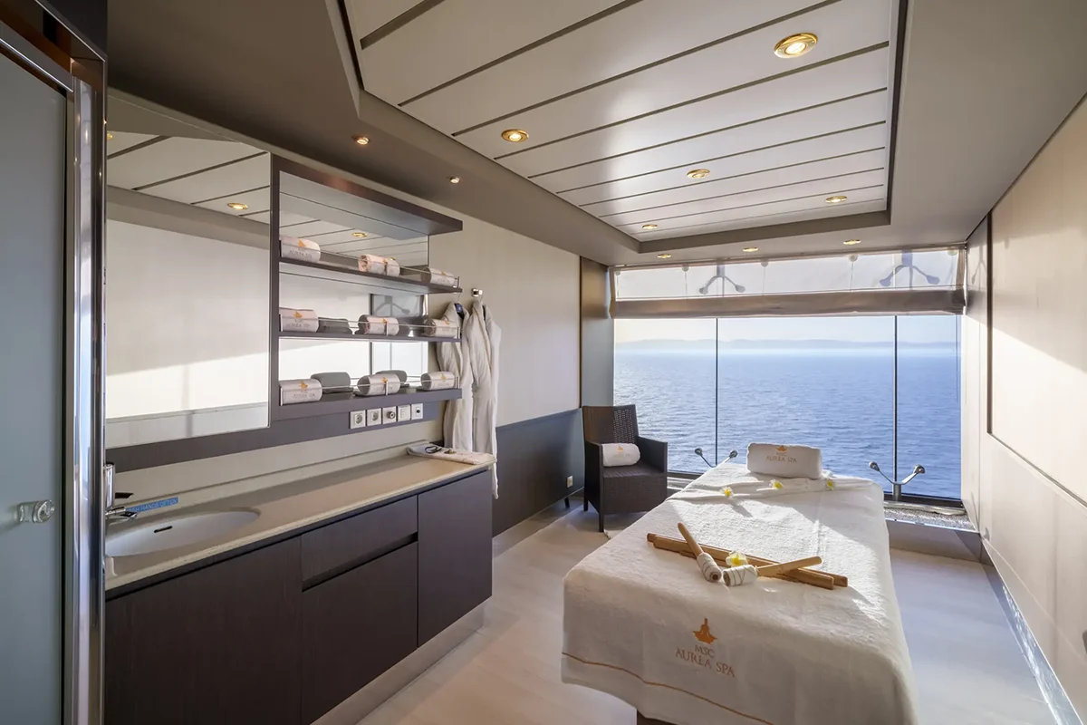 A massage table facing an ocean view.